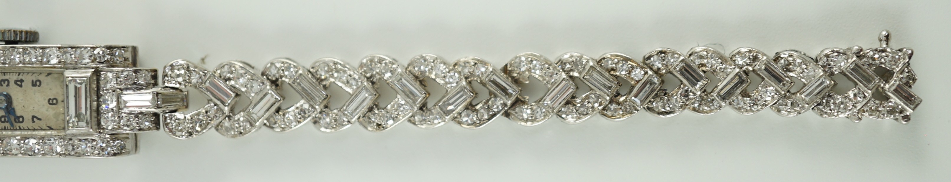 A lady's 1930's/1940's platinum, baguette and round cut diamond set rectangular dial manual wind cocktail watch, on a white gold and baguette and round cut diamond set bracelet, with Asprey box